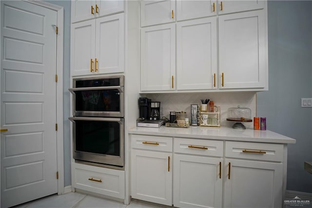 kitchen with white cabinets and double oven