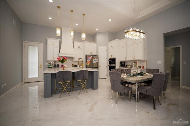 dining area with a notable chandelier and sink