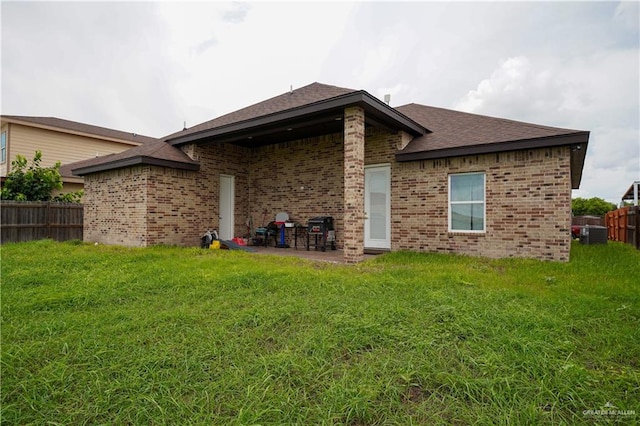 back of house featuring a yard and a patio