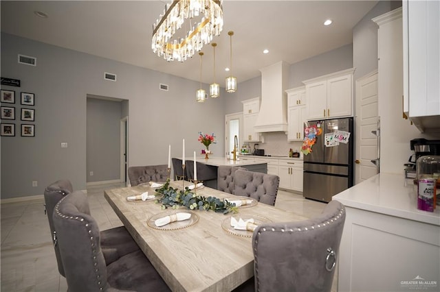 dining space with sink and a chandelier