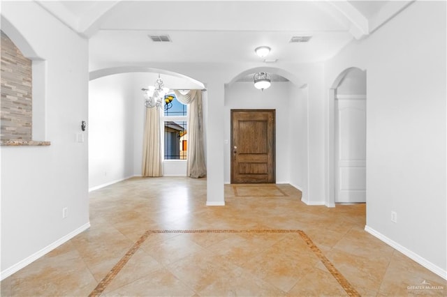 tiled entryway featuring beamed ceiling and a chandelier