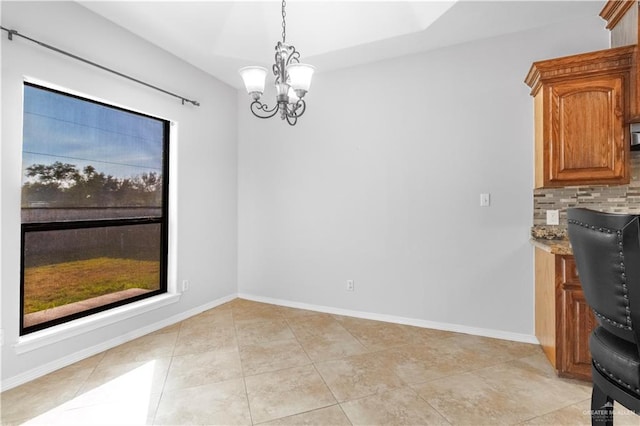 unfurnished dining area with a notable chandelier and light tile patterned floors