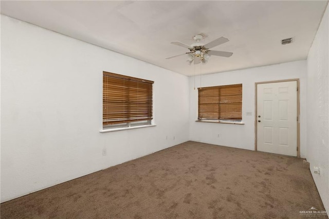 spare room featuring carpet floors and ceiling fan