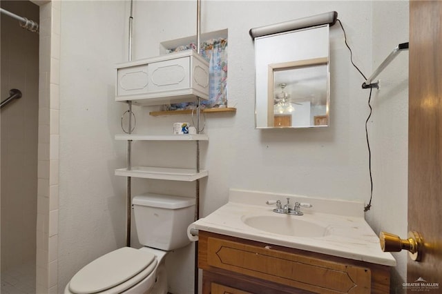 bathroom with vanity, toilet, and a shower