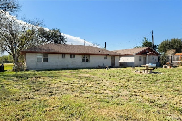 rear view of house featuring a yard