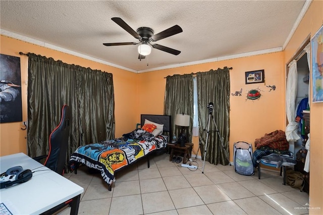 bedroom featuring ceiling fan, crown molding, light tile patterned flooring, and a textured ceiling