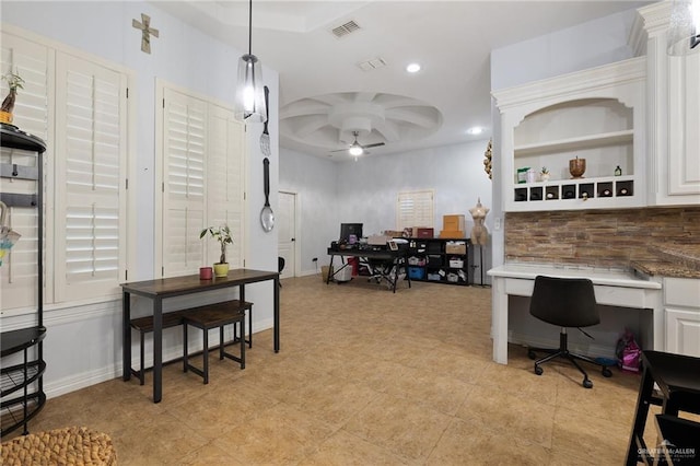 office featuring ceiling fan and built in desk