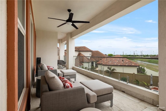 balcony with an outdoor living space and ceiling fan