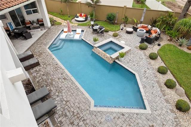 view of swimming pool with an in ground hot tub, an outdoor living space, and a patio area