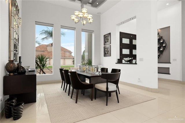 dining area with tile patterned flooring and a notable chandelier