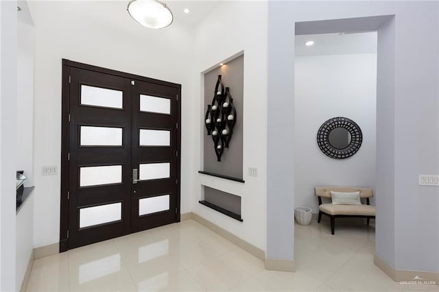 tiled foyer entrance featuring french doors