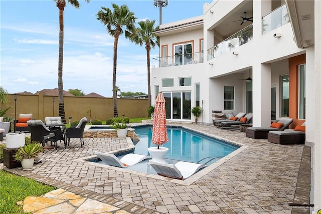 view of pool featuring a patio area, ceiling fan, and an outdoor hangout area