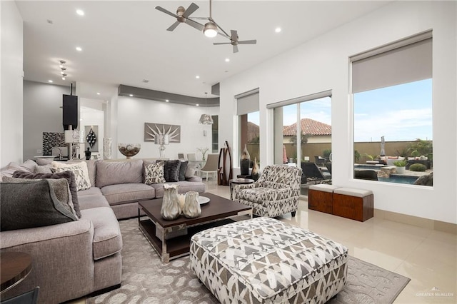 living room featuring light tile patterned floors and ceiling fan