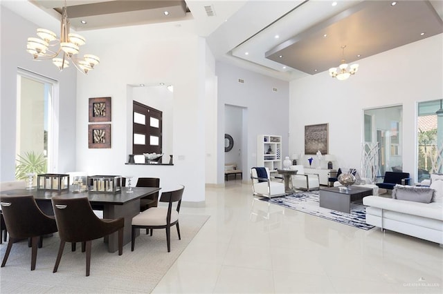 dining space featuring a chandelier, a high ceiling, and light tile patterned floors