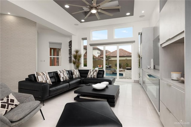 tiled living room with a towering ceiling and ceiling fan