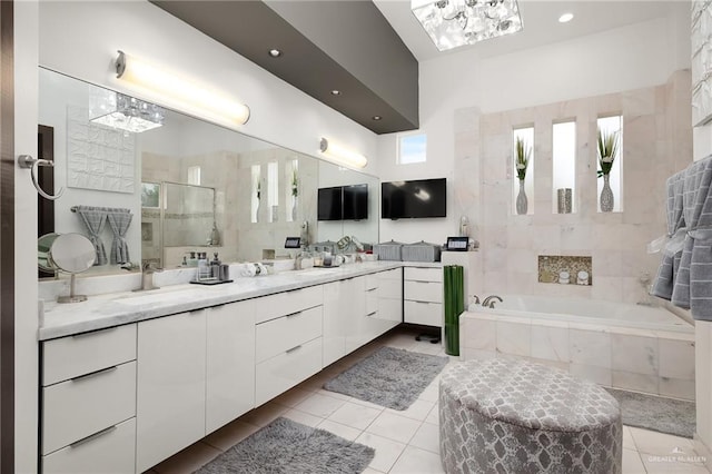 bathroom with shower with separate bathtub, vanity, and tile patterned floors