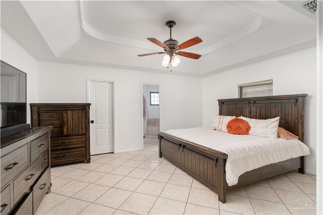 3811 Burr Dr, Edinburg, TX 78542 - bedroom featuring a tray ceiling, light tile patterned floors, and baseboards