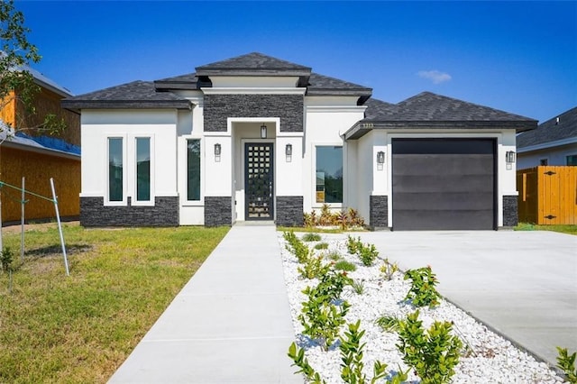 prairie-style house featuring a garage and a front yard