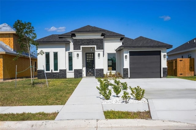 prairie-style home with a garage and a front yard