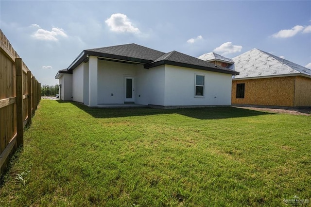 rear view of house with a lawn