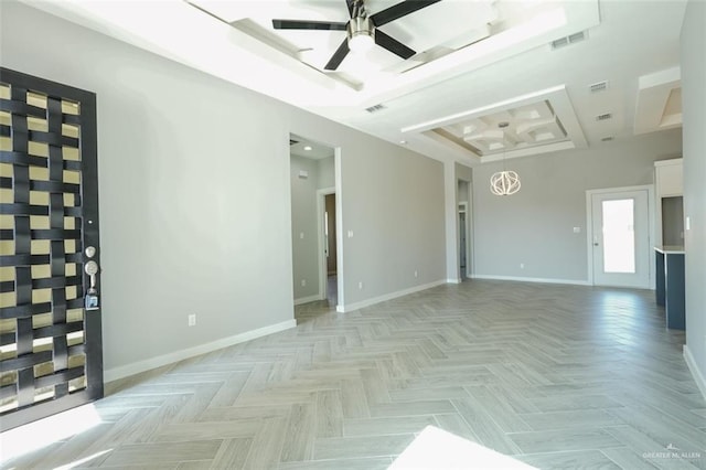 spare room featuring a raised ceiling, ceiling fan, and light parquet floors