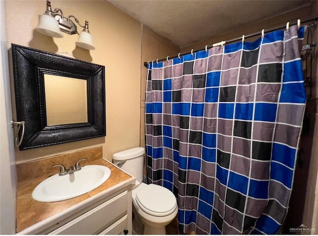 bathroom with vanity, toilet, and curtained shower