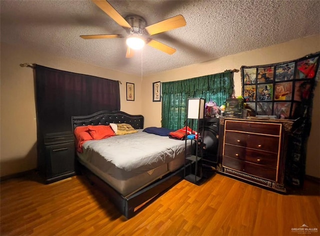 bedroom with hardwood / wood-style floors, a textured ceiling, and ceiling fan