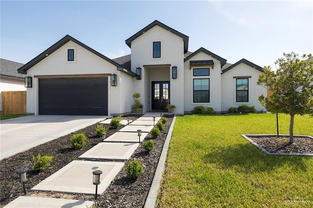 1806 E 28th St, Mission, TX 78574 - view of front facade featuring french doors, stucco siding, a garage, driveway, and a front lawn