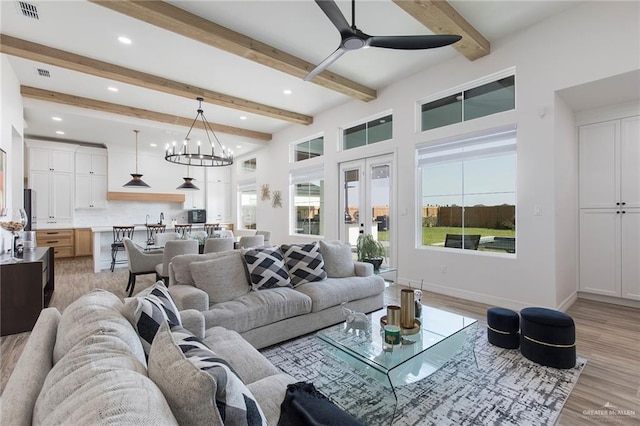 1806 E 28th St, Mission, TX 78574 - living room featuring ceiling fan, light wood-style floors, beamed ceiling, recessed lighting, and a chandelier