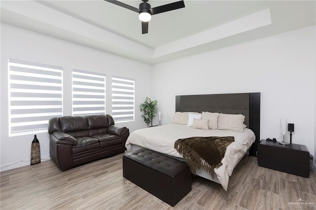 1806 E 28th St, Mission, TX 78574 - bedroom with light wood finished floors, a raised ceiling, and a ceiling fan