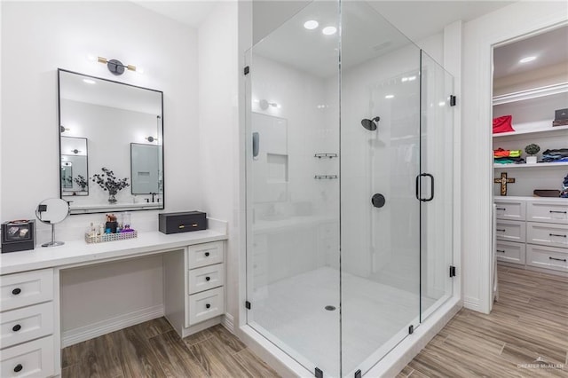 1806 E 28th St, Mission, TX 78574 - bathroom featuring a shower stall, vanity, and wood finished floors