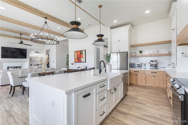 1806 E 28th St, Mission, TX 78574 - kitchen featuring a sink, stainless steel appliances, open shelves, backsplash, and light countertops