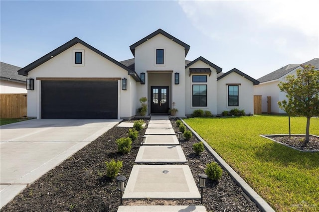 1806 E 28th St, Mission, TX 78574 - view of front of property featuring french doors, stucco siding, a garage, and concrete driveway