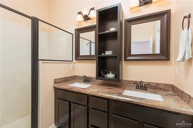 full bath featuring walk in shower, a sink, and double vanity