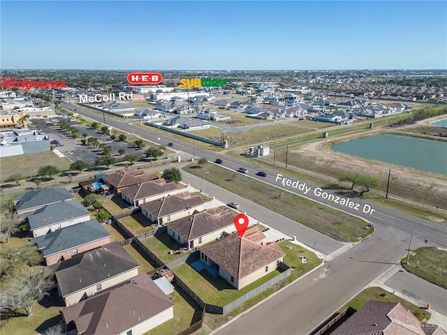 drone / aerial view featuring a water view and a residential view