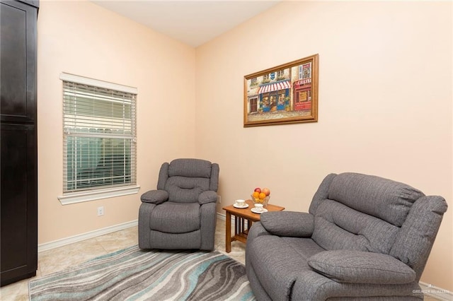 living area with light tile patterned floors and baseboards