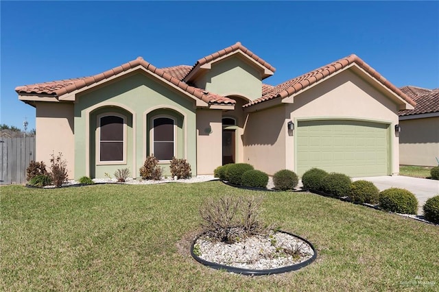 mediterranean / spanish-style home featuring a garage, stucco siding, a tiled roof, and a front yard