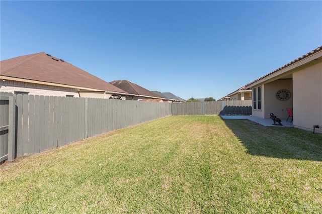 view of yard with a fenced backyard