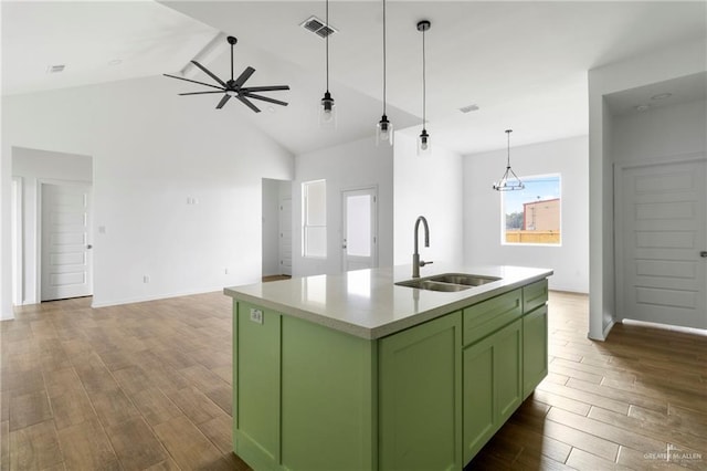 803 Ava Dr, La Feria, TX 78559 - kitchen featuring green cabinets, a sink, open floor plan, high vaulted ceiling, and beam ceiling