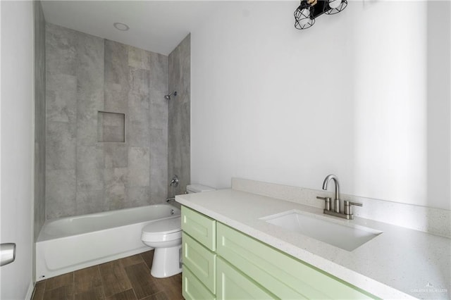 803 Ava Dr, La Feria, TX 78559 - bathroom with toilet, vanity, wood finished floors, and shower / tub combination
