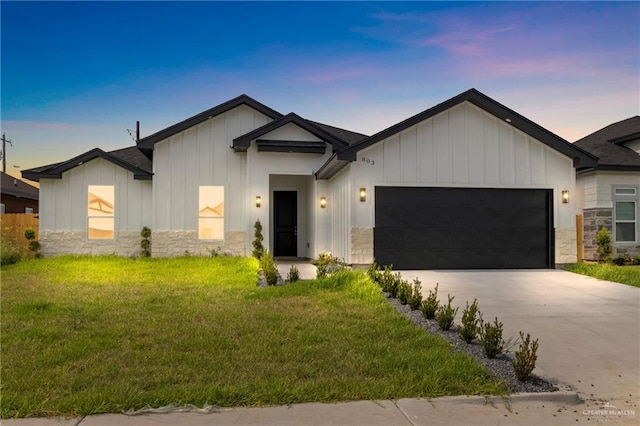 803 Ava Dr, La Feria, TX 78559 - modern inspired farmhouse featuring board and batten siding, a garage, stone siding, a lawn, and driveway