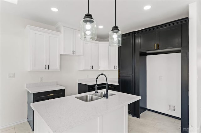 412 Leon Ave, Elsa, TX 78542 - kitchen featuring a kitchen island with sink, dark cabinets, white cabinetry, pendant lighting, and recessed lighting