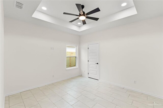 412 Leon Ave, Elsa, TX 78542 - spare room featuring a tray ceiling and ceiling fan