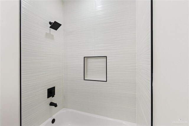 412 Leon Ave, Elsa, TX 78542 - bathroom with tiled shower / bath combo