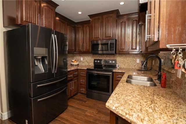 kitchen with dark hardwood / wood-style flooring, backsplash, dark brown cabinets, stainless steel appliances, and sink