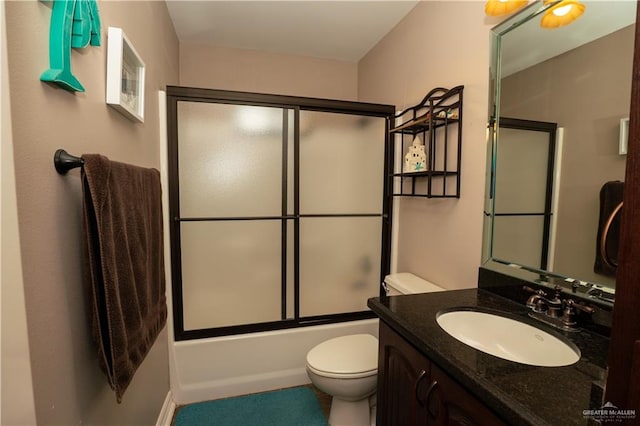 full bathroom featuring vanity, toilet, and enclosed tub / shower combo