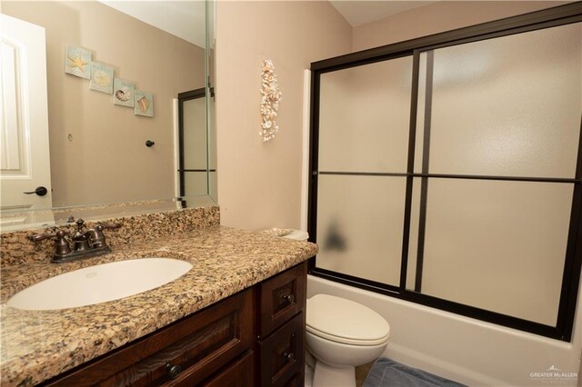 full bathroom featuring vanity, toilet, and enclosed tub / shower combo