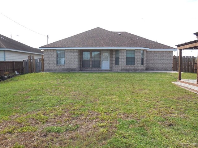 back of house featuring a yard