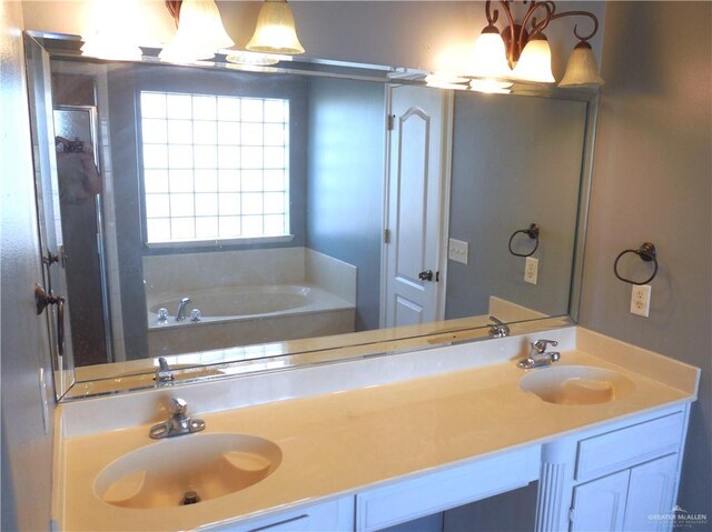 bathroom featuring vanity and a bath