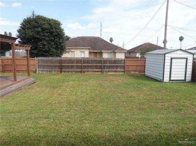 view of yard with a storage shed and a wooden deck